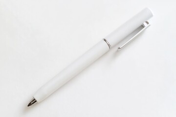 Mockup-ready white pen laid on a seamless white backdrop.