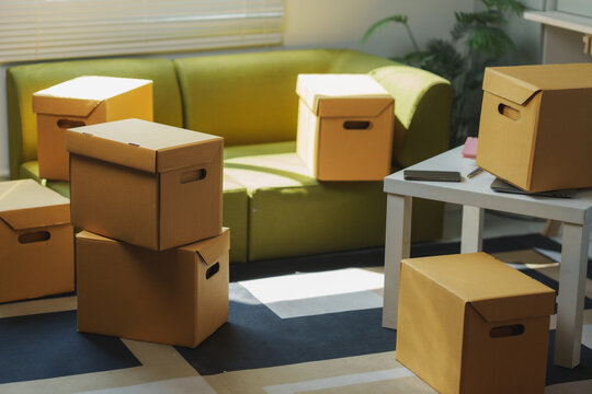 Cardboard boxes stacked in living room during moving day