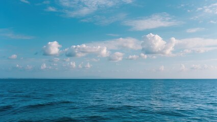 Obraz premium Serene Blue Ocean and Sky Landscape with Cloudy Horizon and Empty Space for Text Overlay in a Peaceful Natural Setting