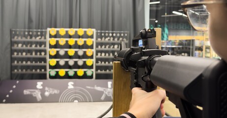  Shooters practicing tactical shooting in a modern indoor gun range.