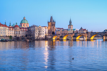 Panoramic evening view of the Charles Bridge over Vltava river and Prague Old town cityscape, in...