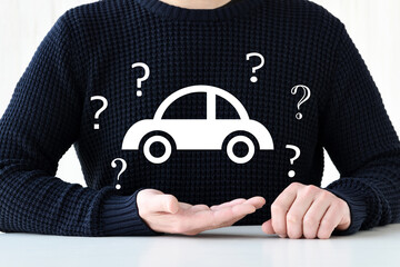 自動車に関して疑問を持つ男性のイメージフォト