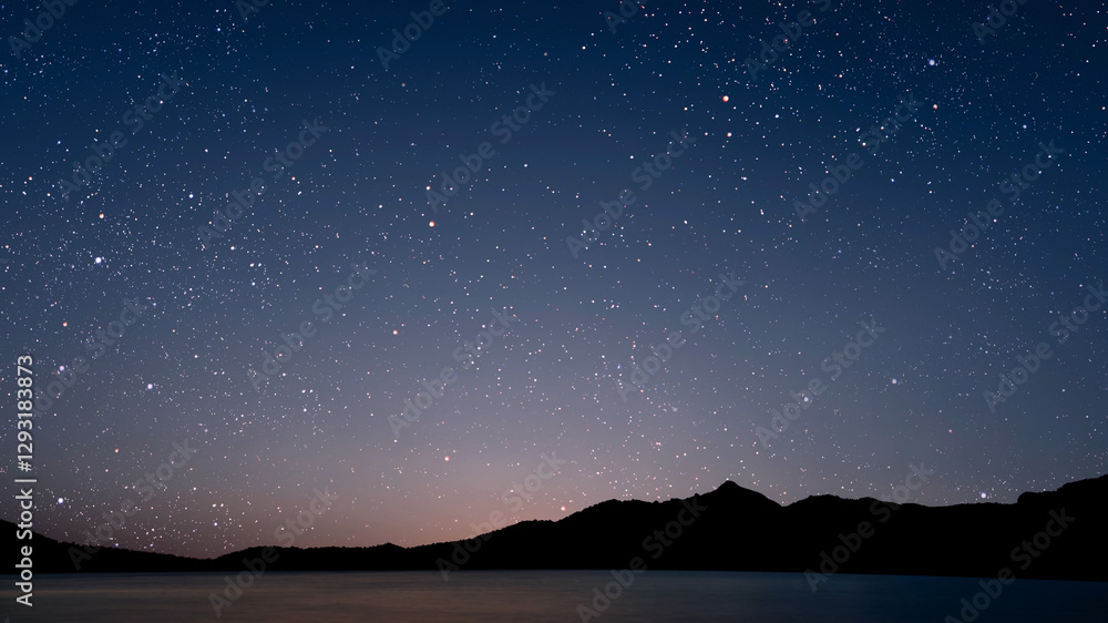 Canvas Prints a movement of stars in the night sky with the view of mountains..