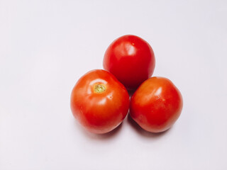 Red, fresh tomatoes on a branch isolated on a white background . Full depth of field.