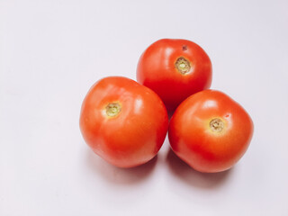 Red, fresh tomatoes on a branch isolated on a white background . Full depth of field.