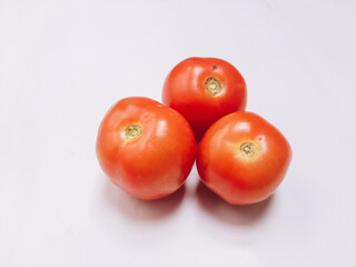 Red, fresh tomatoes on a branch isolated on a white background . Full depth of field.
