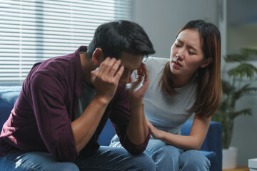 Young woman comforting her sad partner at home