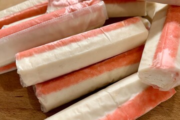 Fresh seafood sticks arranged neatly, showcasing their red and white layers. Ideal for a seafood platter, perfect for gatherings or casual snacking © BoTanya