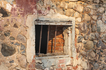 Abandoned Stone Wall with Broken Window and Rusty Bars &ndash; Vintage Architecture Detail