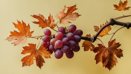 Autumn grape branch with vibrant orange leaves on a soft yellow background perfect for seasonal design and creative projects.