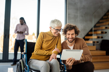 The image includes a person using a wheelchair, depicting inclusivity and teamwork in modern office