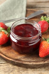 Delicious strawberry sauce and fresh berries on wooden table, closeup