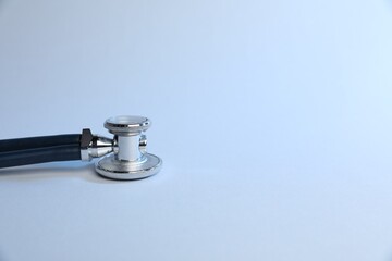 Stethoscope on light background, closeup. Medical tool