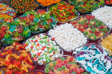 assorted of colorful marmalade and chewable candies on the counter at a candy store in the oriental market in asia