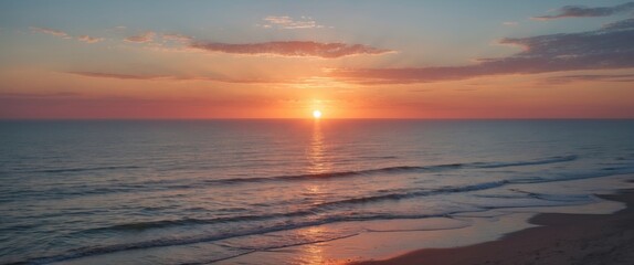 Obraz premium Tranquil sunset over the ocean with gentle waves and serene colors providing ample space for text or messaging overlay.