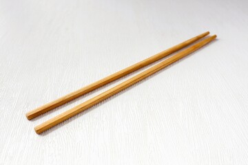Wooden chopsticks on white background	
