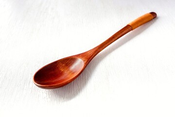 Wooden spoon on white background	
