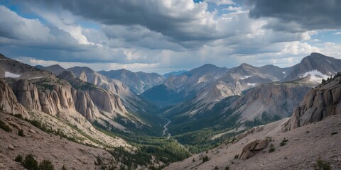 Fototapeta premium Panoramic View of Rocky Mountain Valley Under Dramatic Cloudy Sky with Lush Greenery and Space for Text or Graphics