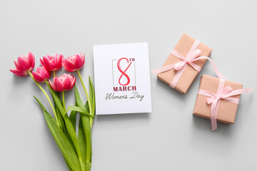 Greeting card with beautiful tulip flowers and gift boxes on grey background. International Women's Day celebration
