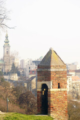 In Belgrade Fortress: a close-up of the old brick watchtower against the backdrop of the Orthodox...