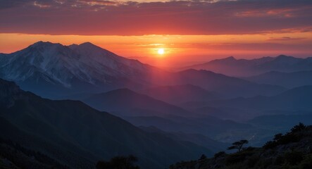 Obraz premium Majestic Mountain Sunset with Layers of Colorful Clouds and Silhouetted Peaks in the Background During Twilight Hours