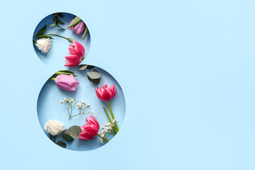 Cut blue paper in shape of figure 8 with beautiful flowers on color background. International Women's Day celebration