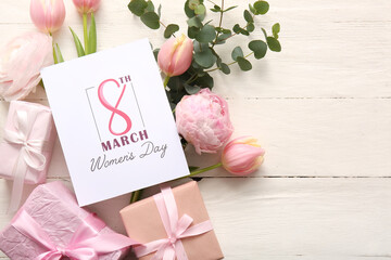 Greeting card with beautiful flowers and gift boxes on white wooden background. International...