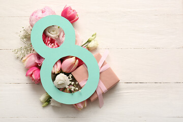 Figure 8 made of paper with beautiful flowers and gift box on white wooden background....