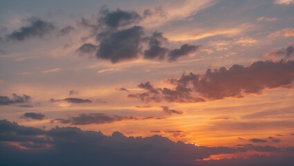 Serene sunset sky with soft clouds showcasing vibrant colors ideal for nature backgrounds and calming scenery.