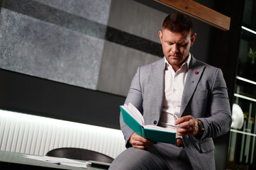 Businessman working and planning about business profits quarter of year at his office. Manager in a...