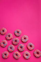 Colorful donuts on a pink background