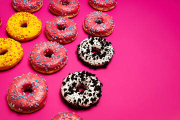 Colorful donuts on a pink background