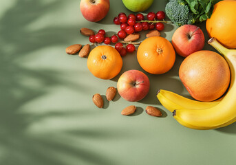 Fresh Citrus Fruits, Nuts, and Green Vegetables on a Colorful Background