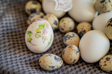 Easter decorated eggs lie on a brown towel, chicken eggs and quail for the holy orthodox holiday of Holy Easter