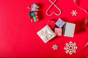 A festive Boxing Day preparation flat lay with Christmas decorations: gift boxes, candy cane,...