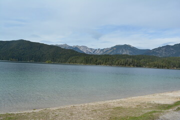 Majestic alpine landscape featuring crystal-clear lakes surrounded by high mountains and dense pine...