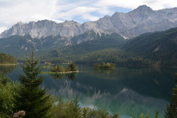 Majestic alpine landscape featuring crystal-clear lakes surrounded by high mountains and dense pine forest. Perfect nature background from the Alps