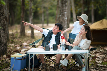 The family of three, Mother and father with a son, going camping. The father is pointing away.