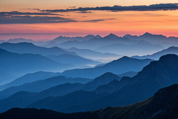 Fototapeta premium A stunning silhouette of mountains at dusk, with layers of peaks fading into the distance