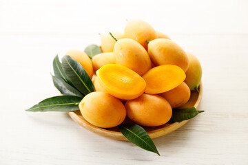 Plum Mango or Marian Plum fruit in wooden tray.