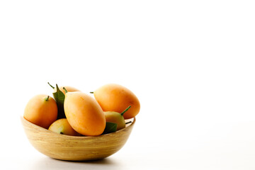 Plum Mango or Marian Plum fruit in wooden tray.