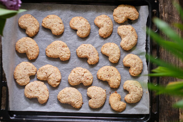 almond crescent cookies on a white parchment
