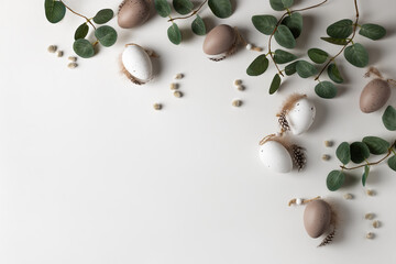 Beautiful spring composition with tender eucalyptus, decorative eggs and willow catkins. Happy Easter concept with copy space for your text.