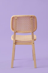 Modern wooden chair on lilac background