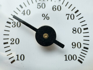 An analog gauge or meter indicating a value around 30 percent on the scale