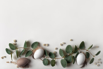 Beautiful spring composition with tender eucalyptus, decorative eggs and willow catkins. Happy Easter concept with copy space for your text.