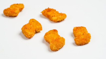 Set of delicious chicken nuggets on white background