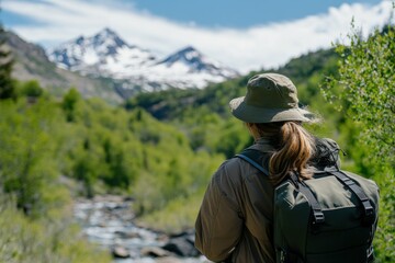 Obraz premium Park ranger observing mountain ecosystem, vibrant outdoor setting, professional gear and serene natural beauty