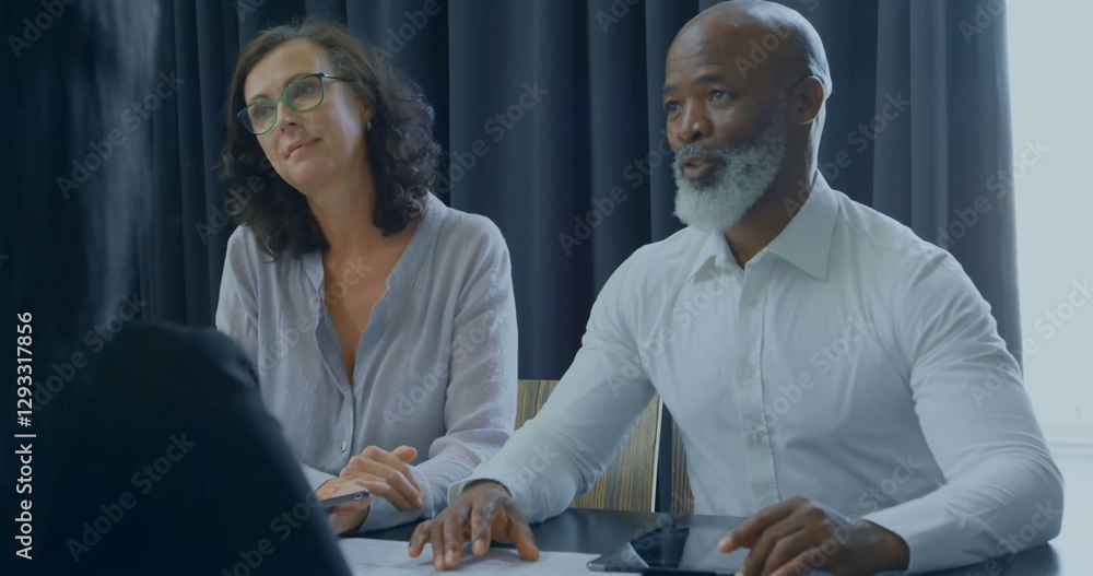 Poster image of financial data processing over diverse colleagues having meeting in office