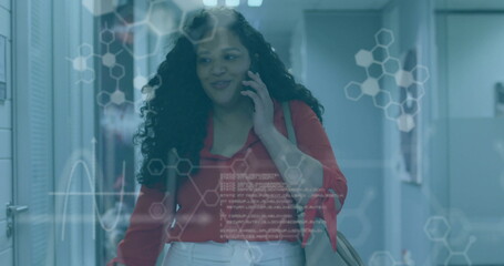 Image of data processing and chemical formula over biracial businesswoman talking on smartphone